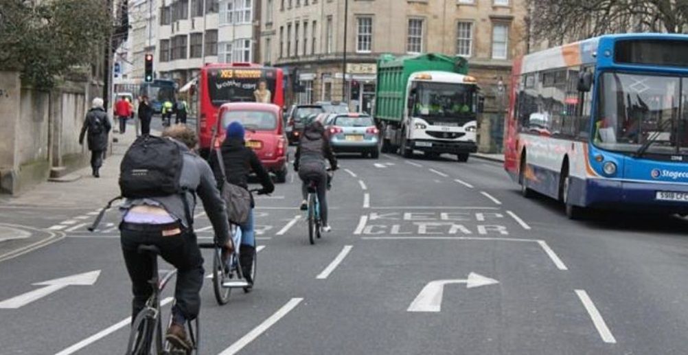 Taxis, buses, cycles, lorries, cars crossing Magdalen Bridge in Oxford