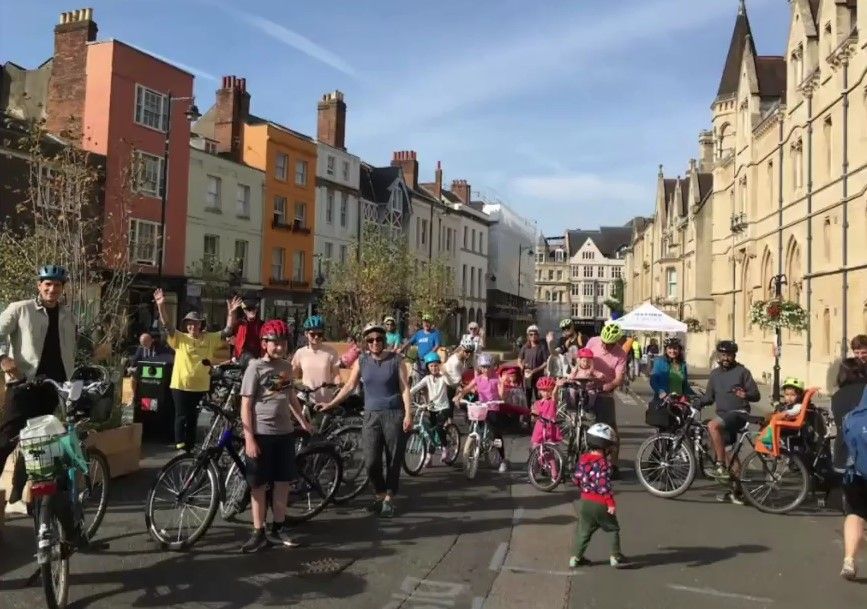 A group of people of all ages with bikes on Broad Street, Oxford