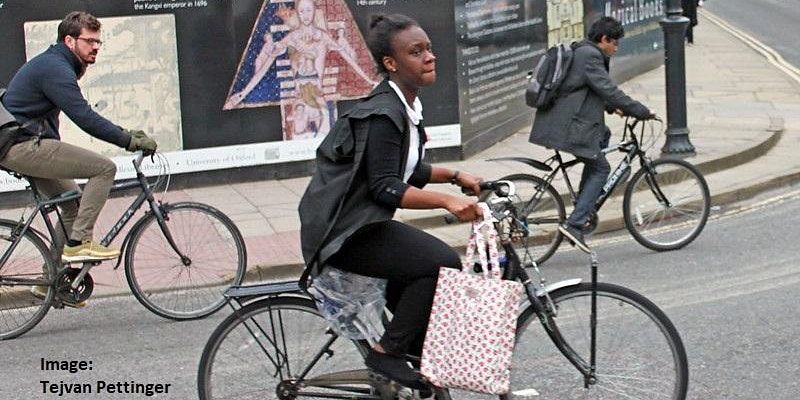 A young woman cycling on an urban road