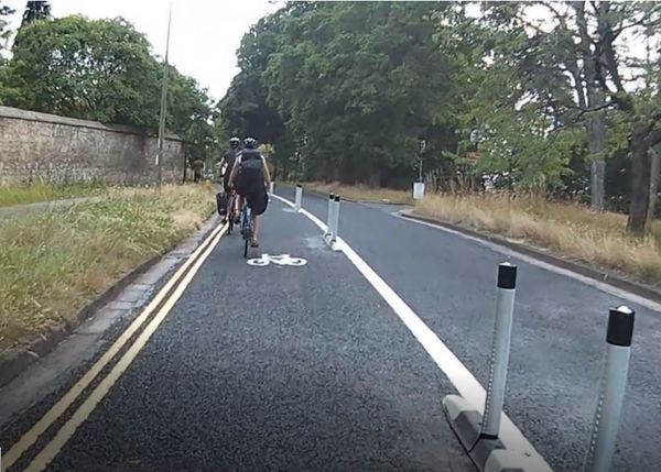 Cyclists using the cycle lane on Warneford Lane in Oxford – now separated from motor vehicles by traffic wands and orcas